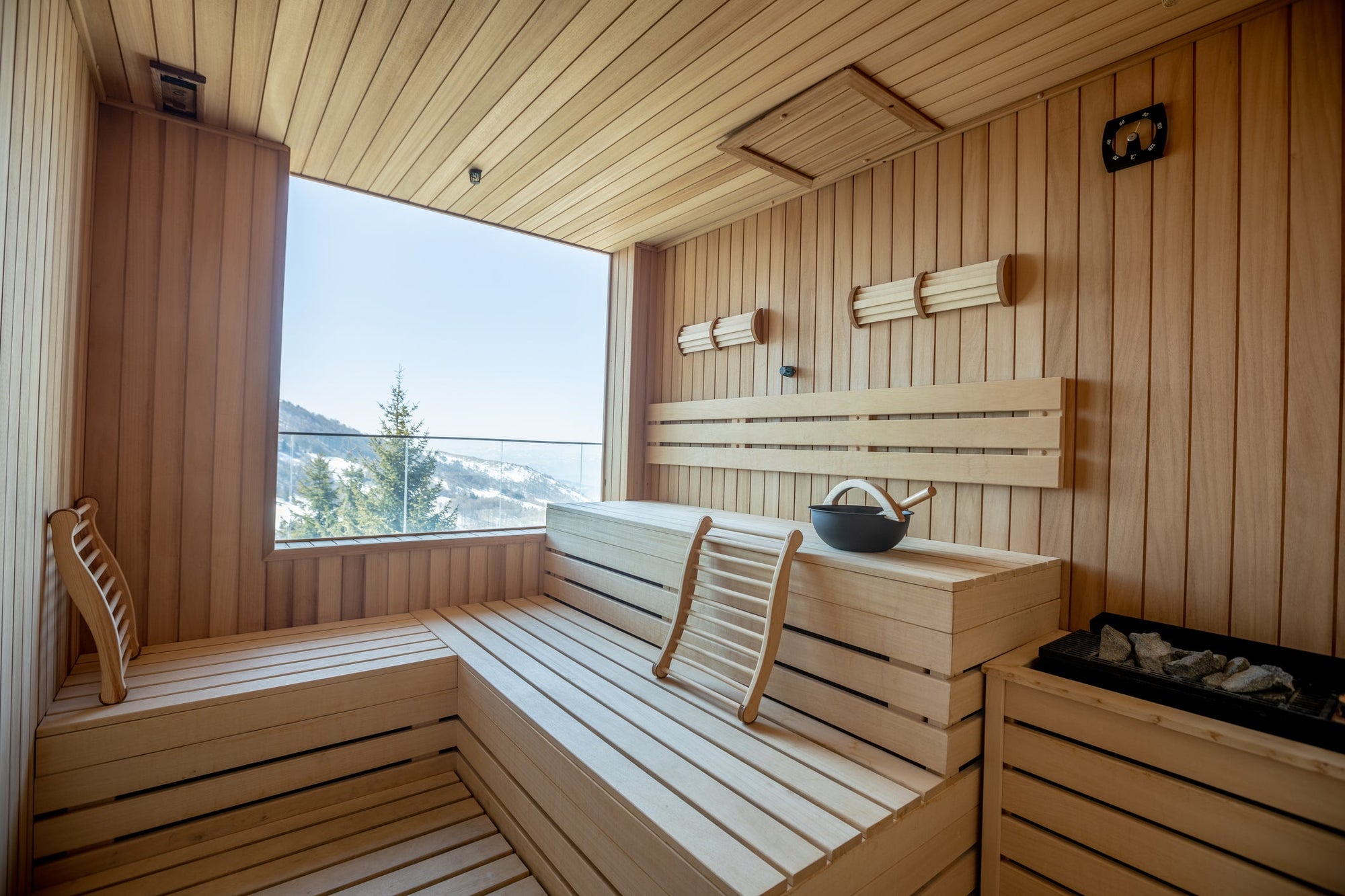 A luxurious sauna with a window overlooking a mountain view