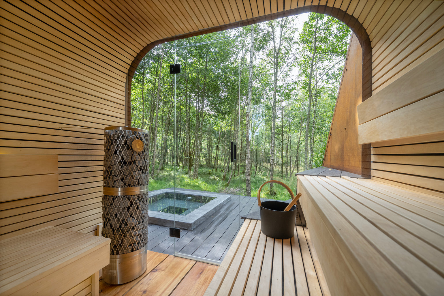 The inside of a sauna looking out to the trees in the distance