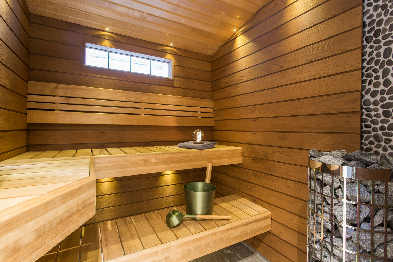 A sauna with accessories on the benches