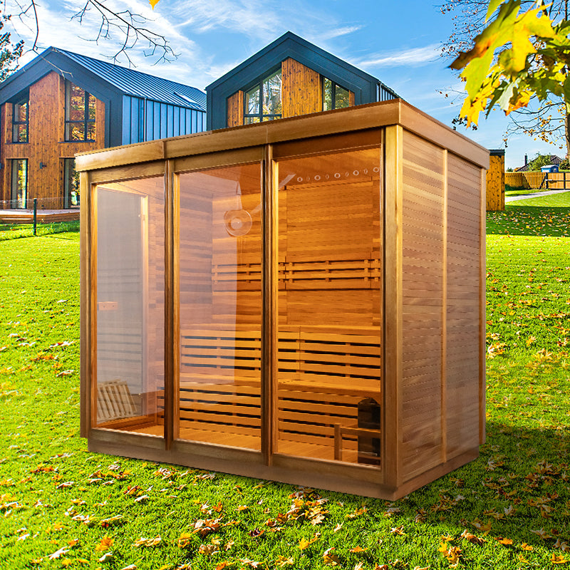 An outdoor cabin sauna sitting on the grass in front of houses